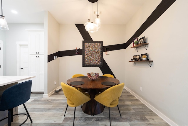 dining area with baseboards, recessed lighting, and light wood finished floors