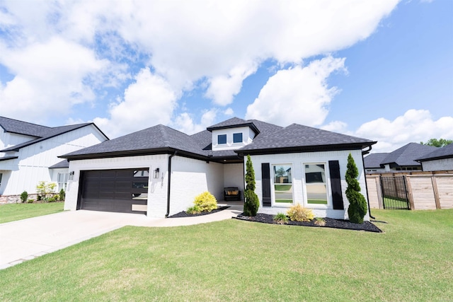 prairie-style house featuring driveway, brick siding, fence, a front lawn, and an attached garage
