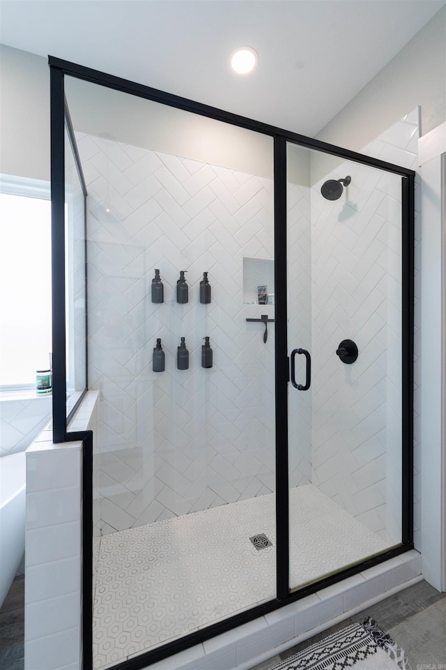 bathroom featuring a freestanding bath, a shower stall, and recessed lighting
