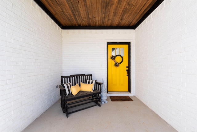 view of exterior entry with brick siding