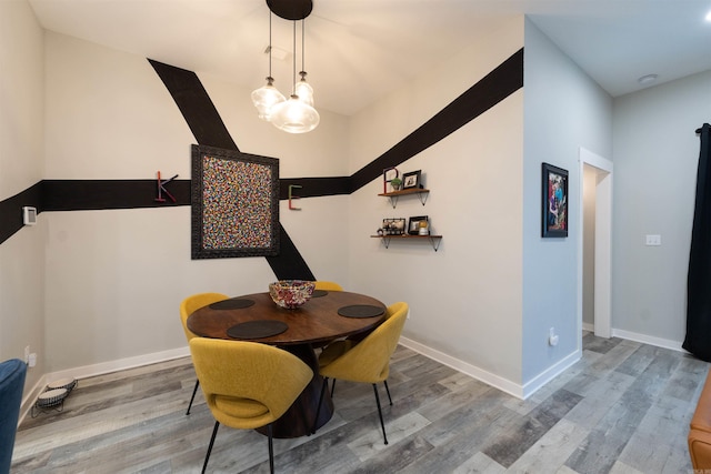 dining room with baseboards and wood finished floors