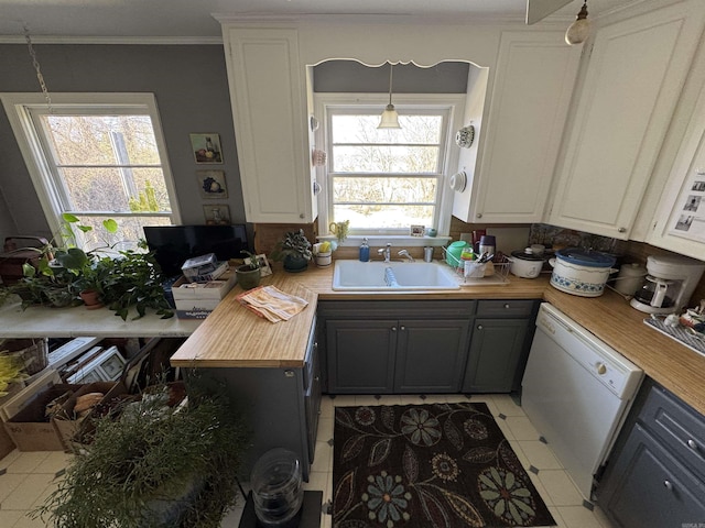 kitchen featuring white cabinetry, butcher block counters, a sink, and dishwasher