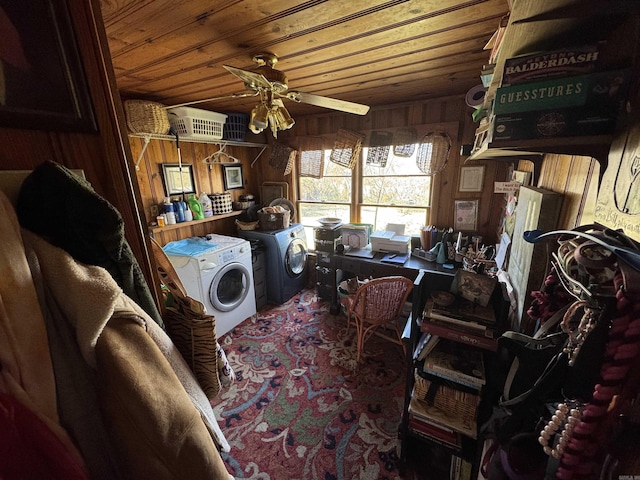 washroom featuring washing machine and clothes dryer, wooden walls, laundry area, a ceiling fan, and wood ceiling