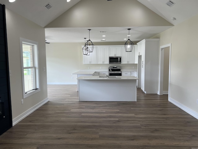 kitchen with light countertops, white cabinetry, appliances with stainless steel finishes, and visible vents
