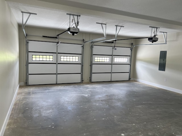 garage featuring baseboards, a garage door opener, and electric panel