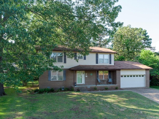 traditional-style home featuring brick siding, a garage, a front yard, covered porch, and driveway