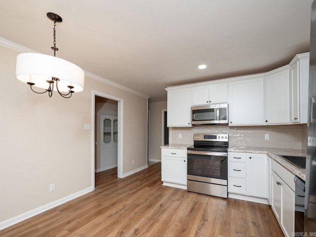 kitchen featuring decorative backsplash, crown molding, appliances with stainless steel finishes, baseboards, and white cabinetry