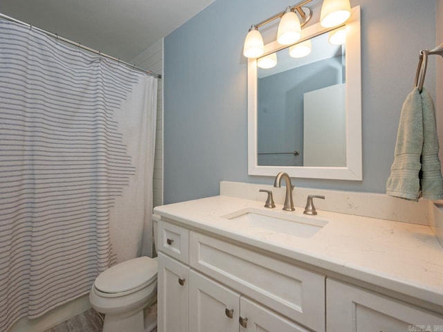 bathroom featuring vanity, toilet, and a shower with shower curtain