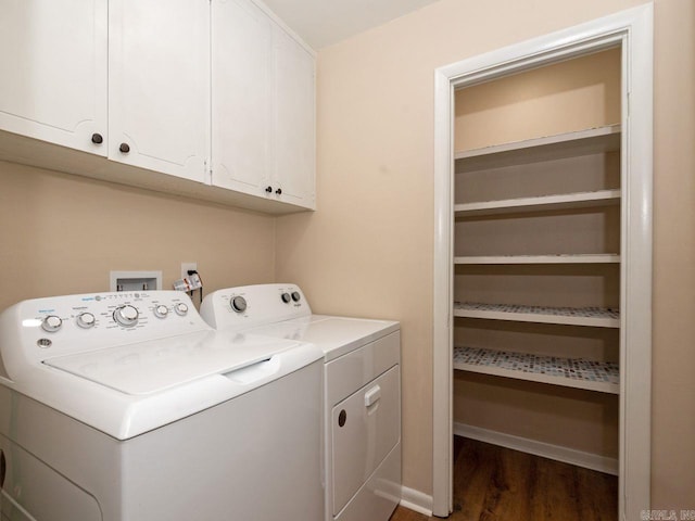 laundry room with baseboards, dark wood finished floors, cabinet space, and washer and clothes dryer