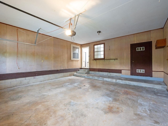 garage with wood walls and visible vents