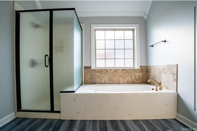 bathroom featuring crown molding, wood finished floors, and a shower stall