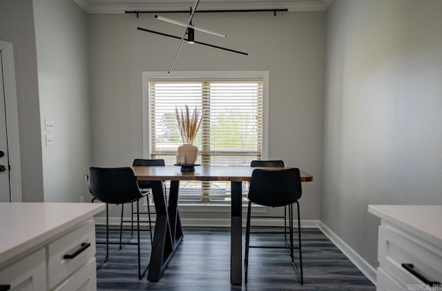 dining area with crown molding, dark wood finished floors, and baseboards