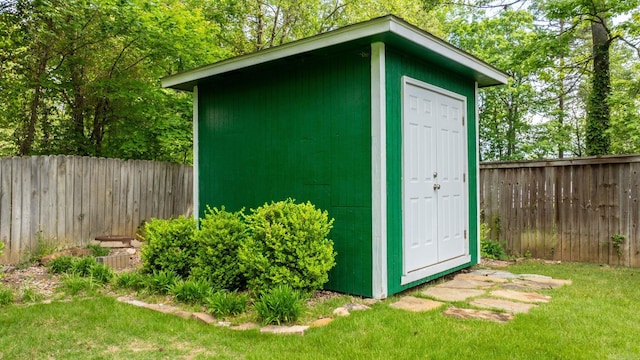 view of shed with a fenced backyard