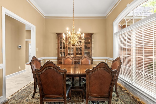 dining room featuring wainscoting, a notable chandelier, and ornamental molding