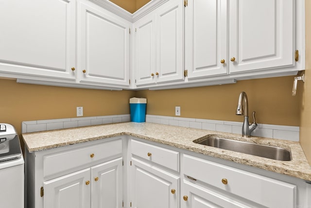 washroom featuring a sink and washer / dryer