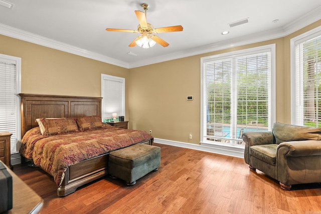 bedroom with ornamental molding, a ceiling fan, and wood finished floors