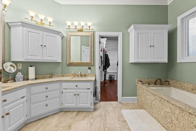 full bathroom with baseboards, ornamental molding, a bath, and vanity
