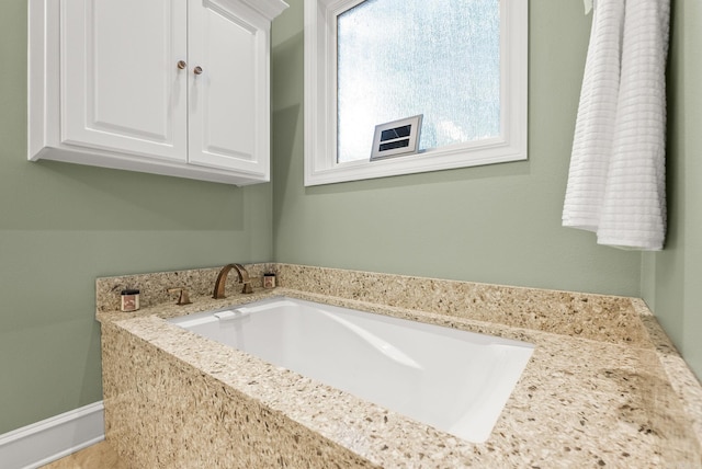 bathroom featuring a washtub