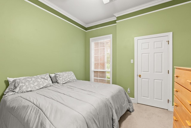 bedroom featuring crown molding, baseboards, and light carpet