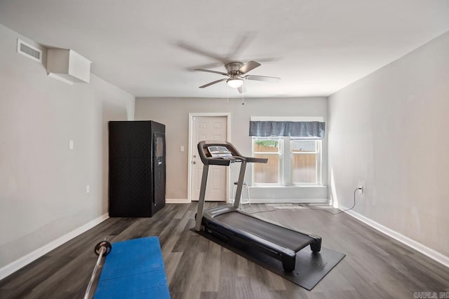 exercise area featuring baseboards, ceiling fan, wood finished floors, and visible vents