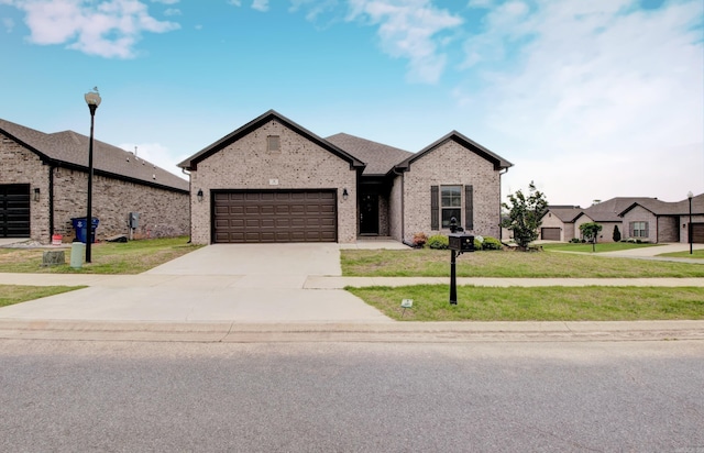 10 Luke Ct, Maumelle, AR 72113 - view of front of home featuring an attached garage, a front yard, driveway, and brick siding