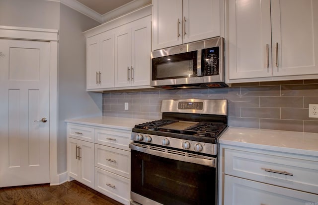 10 Luke Ct, Maumelle, AR 72113 - kitchen with light countertops, stainless steel appliances, white cabinetry, backsplash, and ornamental molding