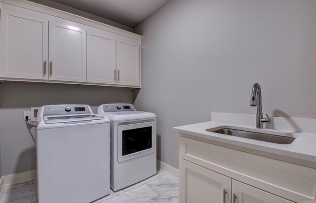10 Luke Ct, Maumelle, AR 72113 - laundry room featuring cabinet space, a sink, marble finish floor, baseboards, and washer and clothes dryer