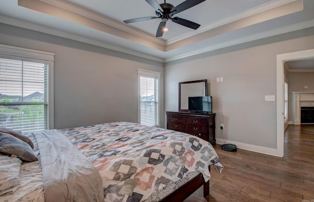 10 Luke Ct, Maumelle, AR 72113 - bedroom with crown molding, a raised ceiling, a fireplace, baseboards, and wood finished floors