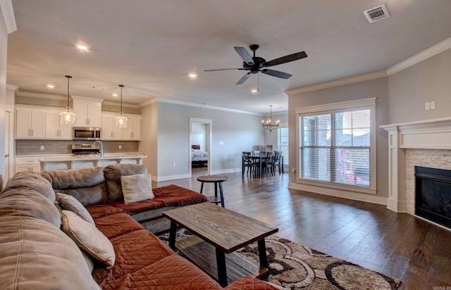 10 Luke Ct, Maumelle, AR 72113 - living room with a stone fireplace, visible vents, baseboards, ceiling fan with notable chandelier, and recessed lighting