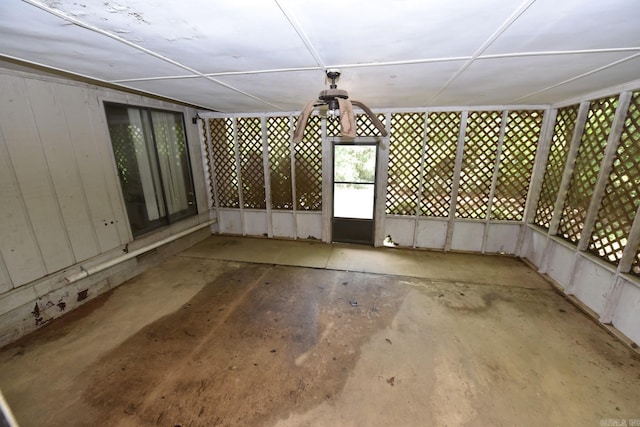 exterior space with a ceiling fan and unfinished concrete floors
