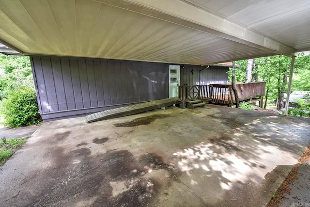 view of patio / terrace with a wooden deck and a carport