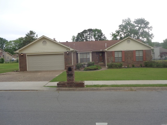 ranch-style home featuring concrete driveway, brick siding, an attached garage, and a front yard
