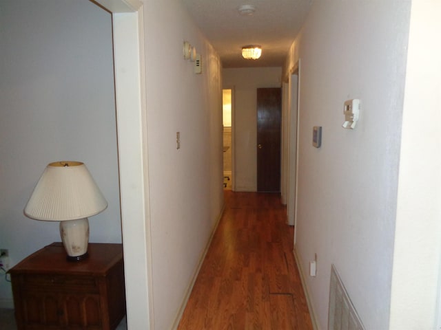 hall with wood finished floors