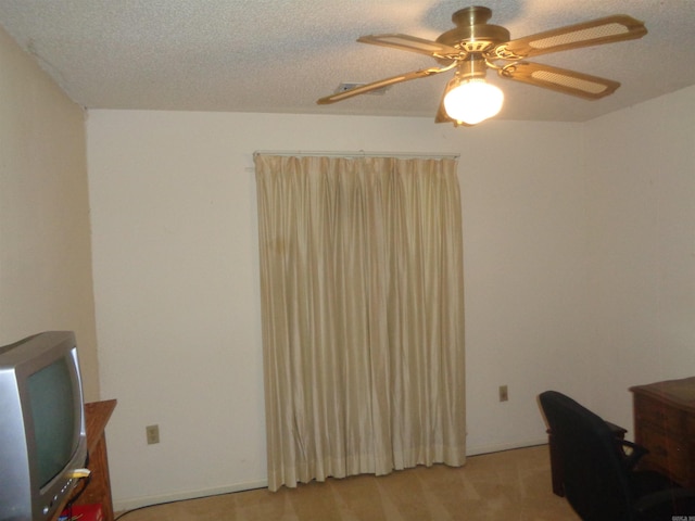 office with a ceiling fan, a textured ceiling, and light colored carpet