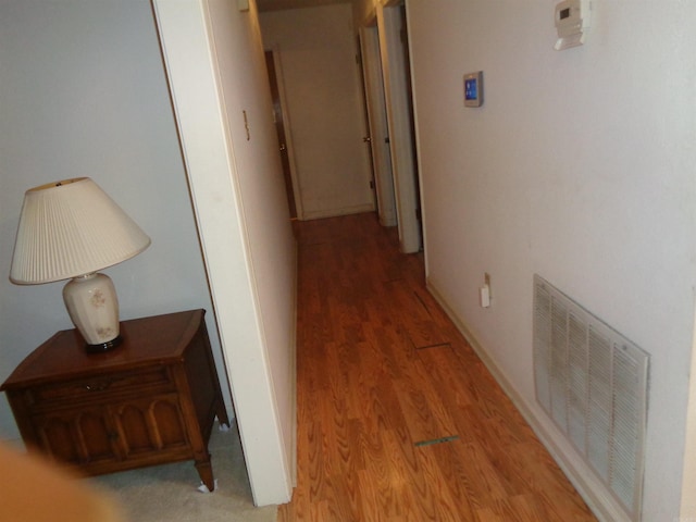 hall with light wood-style flooring and visible vents