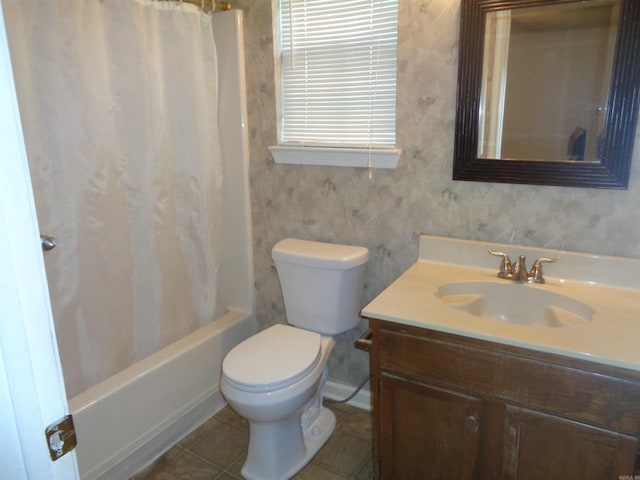 bathroom featuring vanity, tile patterned flooring, shower / bath combo, and toilet