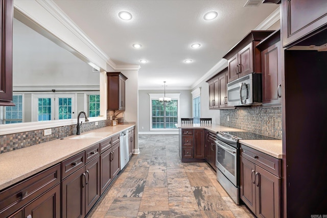 5485 Viney Creek Ln, Jonesboro, AR 72404 - kitchen with stainless steel appliances, ornamental molding, a sink, recessed lighting, and a chandelier