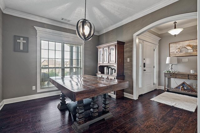 5485 Viney Creek Ln, Jonesboro, AR 72404 - dining space featuring dark wood-type flooring, arched walkways, baseboards, and ornamental molding