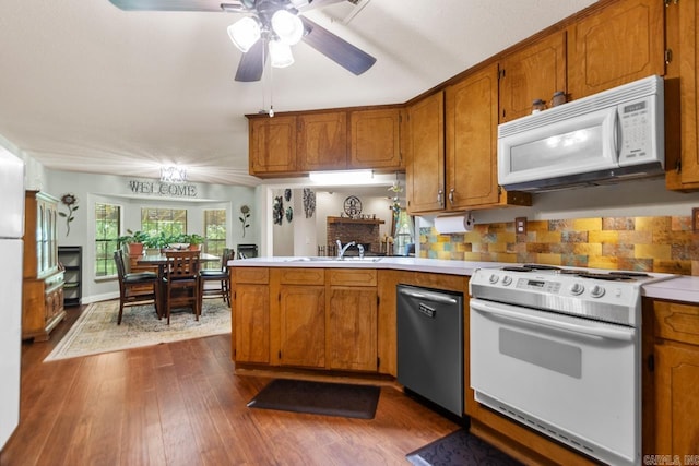 68 Tanner Dr, Bigelow, AR 72016 - kitchen with a ceiling fan, brown cabinets, a sink, a peninsula, and white appliances
