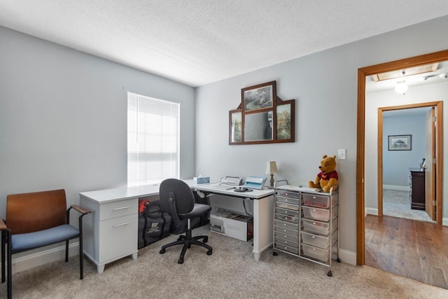 68 Tanner Dr, Bigelow, AR 72016 - office area featuring a textured ceiling, light colored carpet, and baseboards