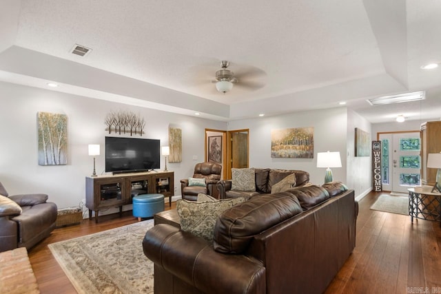 68 Tanner Dr, Bigelow, AR 72016 - living area featuring a raised ceiling, a ceiling fan, dark wood finished floors, and visible vents