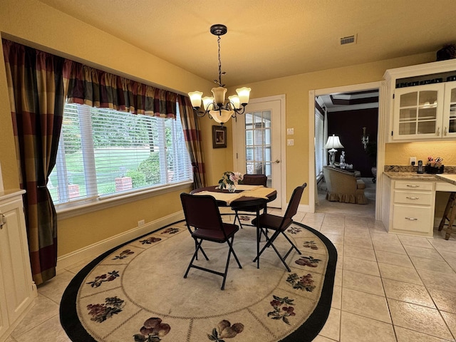 dining room featuring visible vents, baseboards, light tile patterned floors, and a notable chandelier