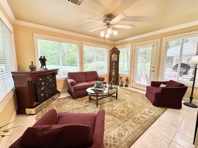 living room with tile patterned flooring, plenty of natural light, a textured ceiling, and ceiling fan