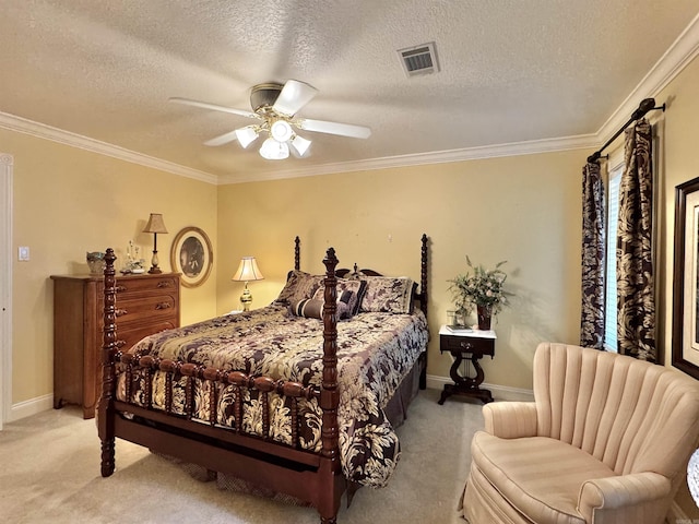 bedroom with crown molding, carpet, a textured ceiling, and visible vents