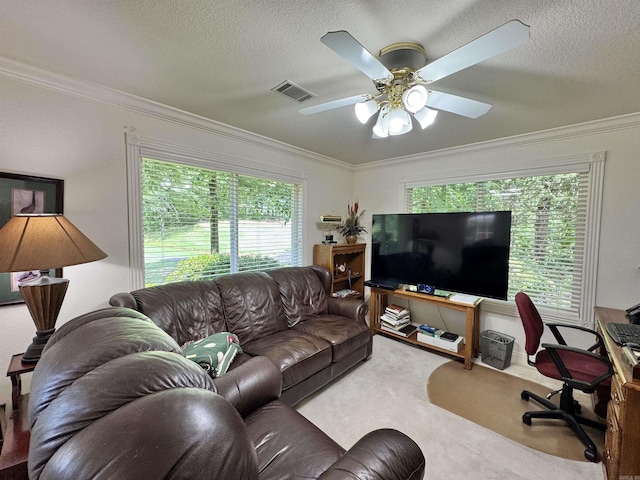 living area featuring carpet floors, a ceiling fan, crown molding, and visible vents