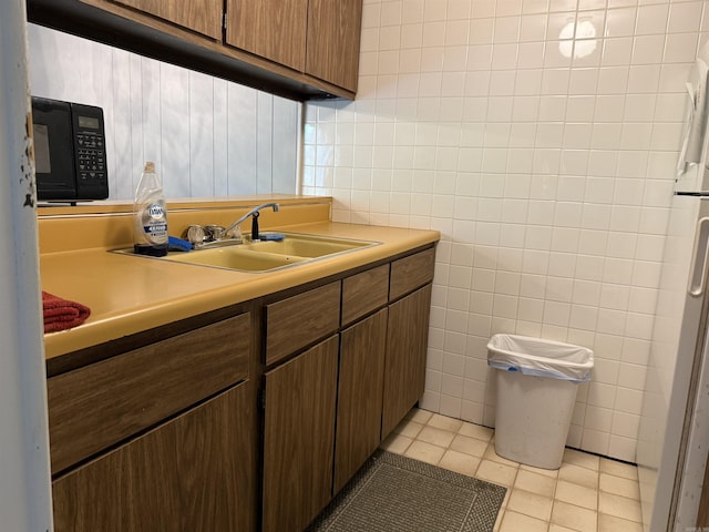 bathroom featuring tile walls, tile patterned flooring, and vanity