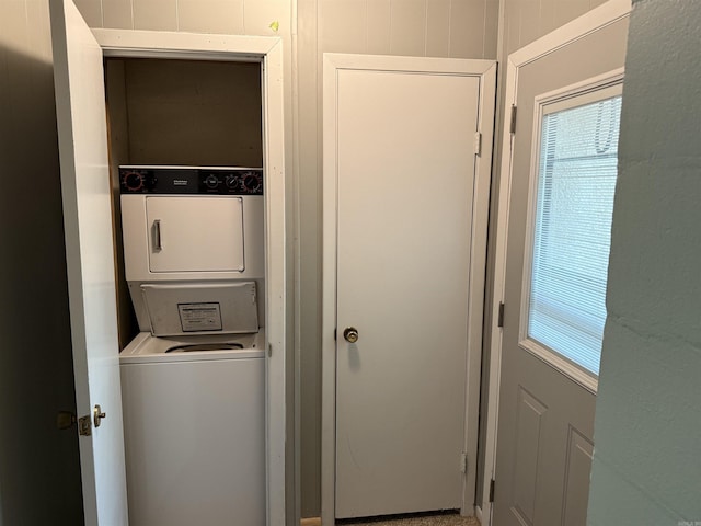 laundry room with laundry area and stacked washer / dryer