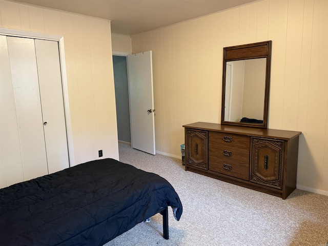 bedroom featuring baseboards and light colored carpet