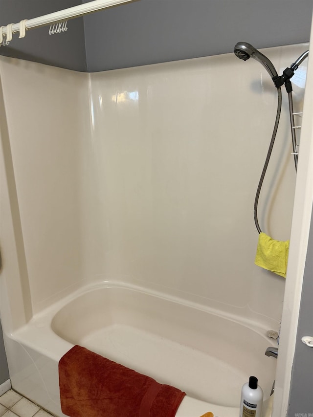 bathroom with tile patterned flooring and tub / shower combination