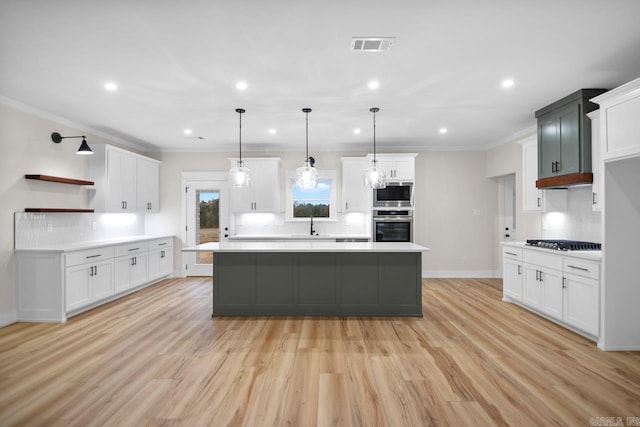 139 Hudson Dr, Sheridan, AR 72150 - kitchen featuring decorative backsplash, open shelves, light wood-style floors, light countertops, and stainless steel appliances